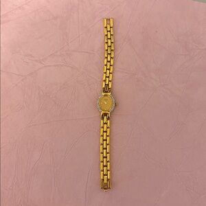 Bulova quartz watch.   Elegant Gold-Tone Watch with Crystal Accents
